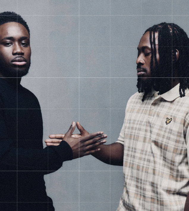 Two men wearing Lyle and Scott standing face to face with a grid overlay on a gray background